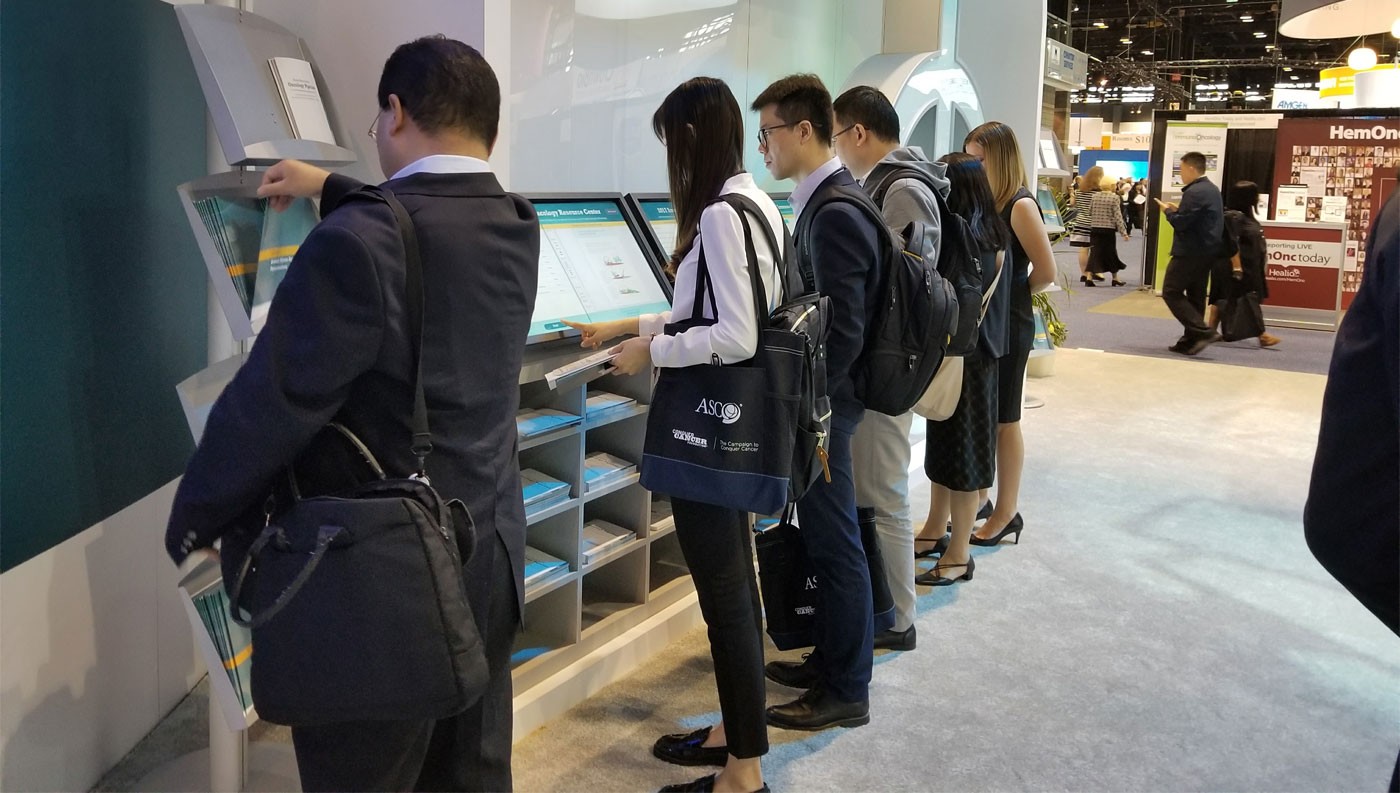 Group of visitors using the kiosk stations simultaneously
